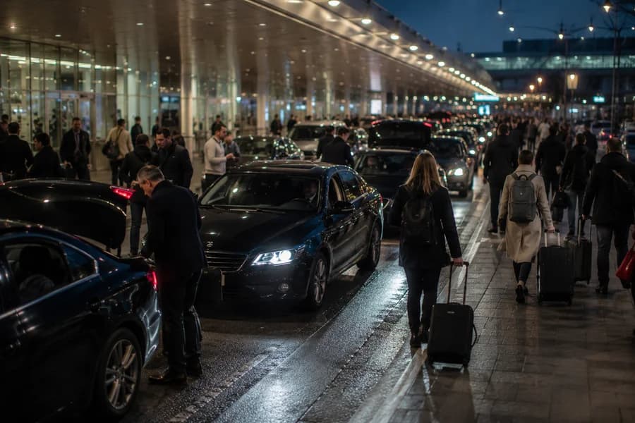 A passenger handoff at a hotel taxi pickup.